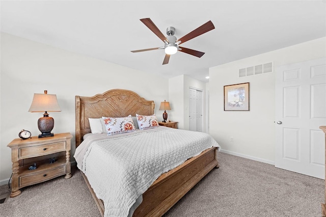 bedroom featuring visible vents, baseboards, light colored carpet, a closet, and a ceiling fan