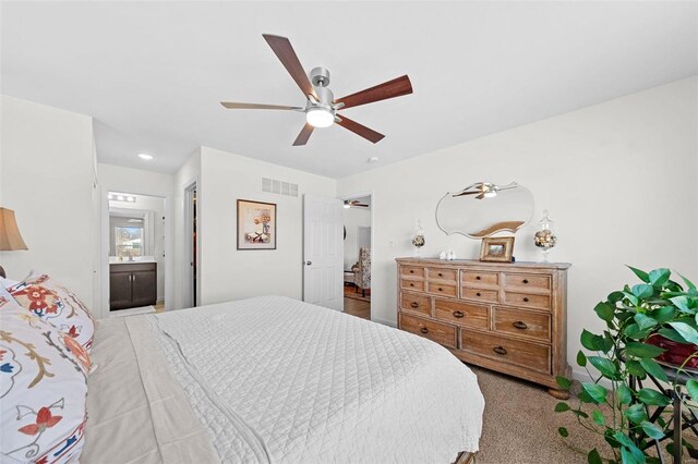 bedroom featuring connected bathroom, visible vents, ceiling fan, and carpet flooring