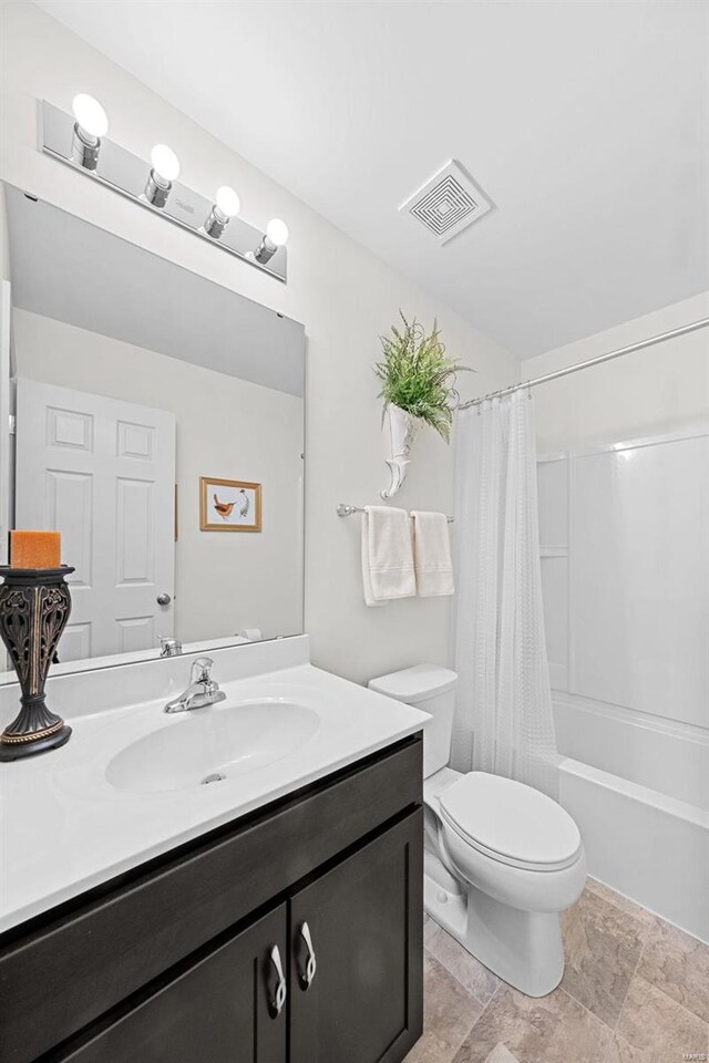 bathroom featuring visible vents, shower / tub combo, toilet, and vanity