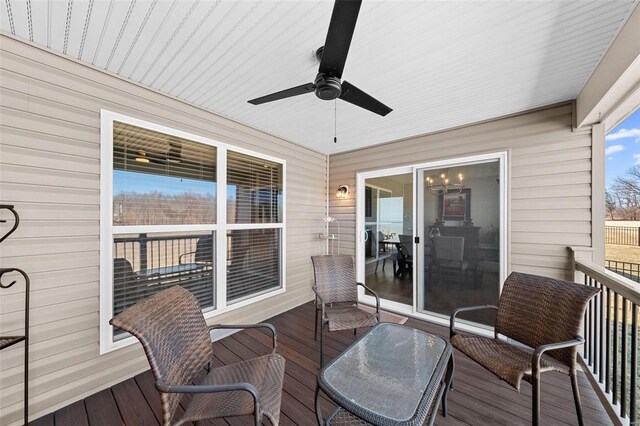 wooden terrace featuring ceiling fan