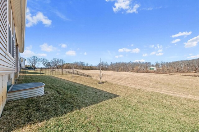 view of yard with a rural view and fence