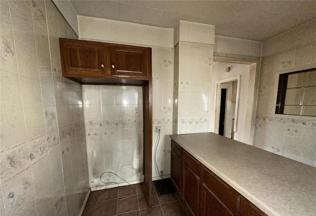 bathroom with tile walls and tile patterned floors