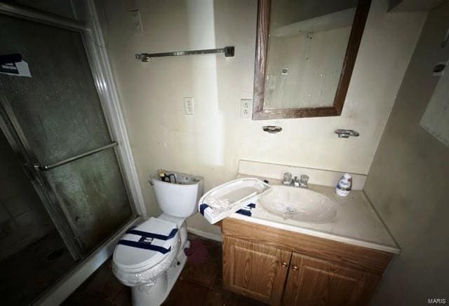 full bathroom with a shower stall, vanity, and toilet