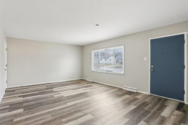 entryway featuring wood finished floors, visible vents, and baseboards