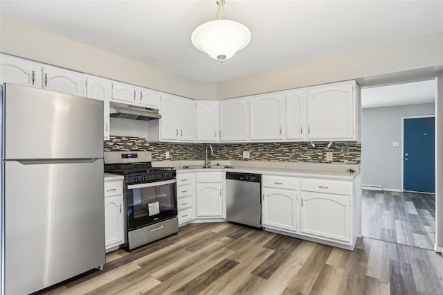 kitchen featuring hanging light fixtures, appliances with stainless steel finishes, white cabinetry, and under cabinet range hood