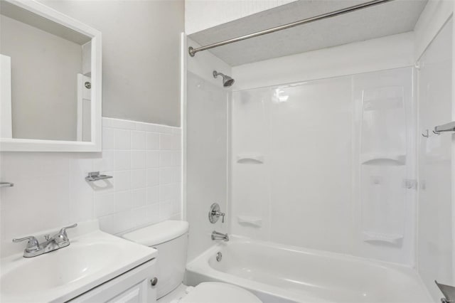 full bath with vanity, shower / tub combination, toilet, and tile walls