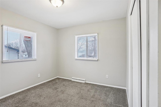 spare room with carpet, visible vents, and baseboards