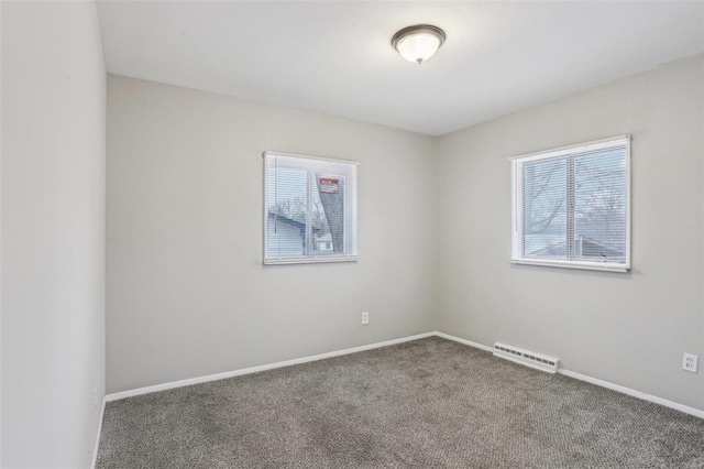 carpeted spare room with baseboards and visible vents