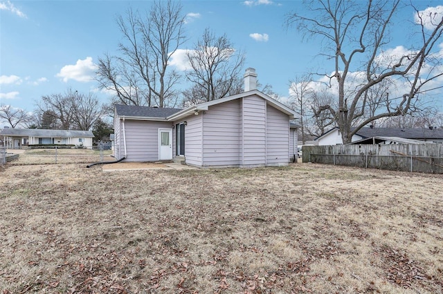 back of house featuring fence