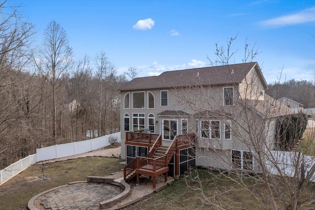 back of house featuring a fenced backyard, a deck, and stairs