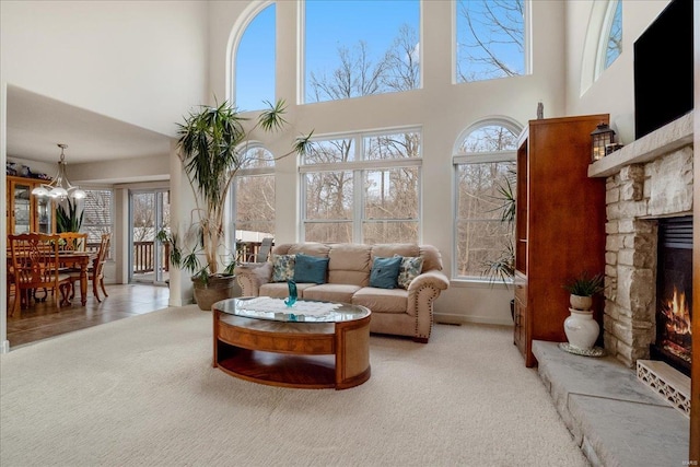 sunroom with a fireplace and an inviting chandelier