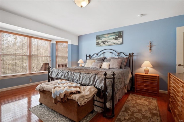 bedroom featuring baseboards and hardwood / wood-style floors