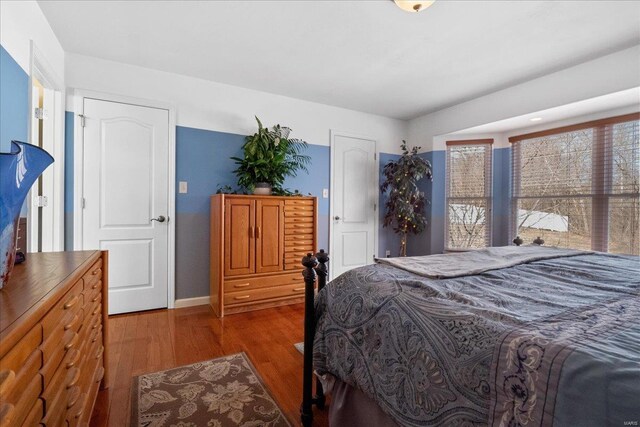 bedroom featuring wood finished floors and baseboards