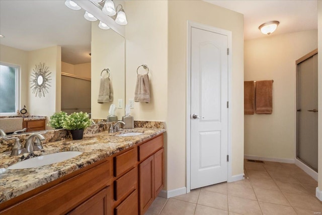 bathroom featuring double vanity, tile patterned flooring, a sink, and a shower stall