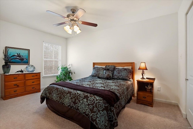 bedroom with light carpet, ceiling fan, and baseboards