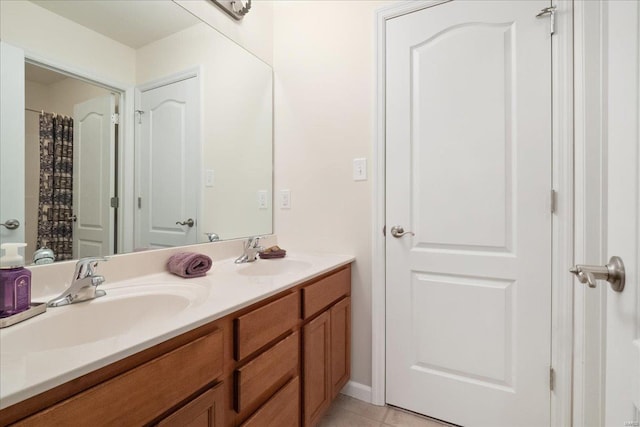 full bath with tile patterned flooring, a sink, and double vanity