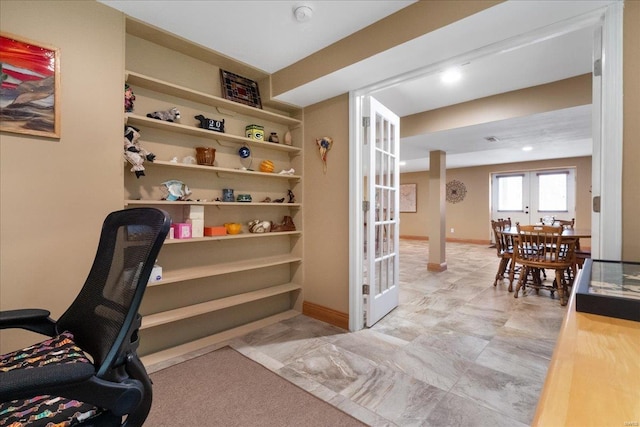 office area featuring built in shelves and baseboards