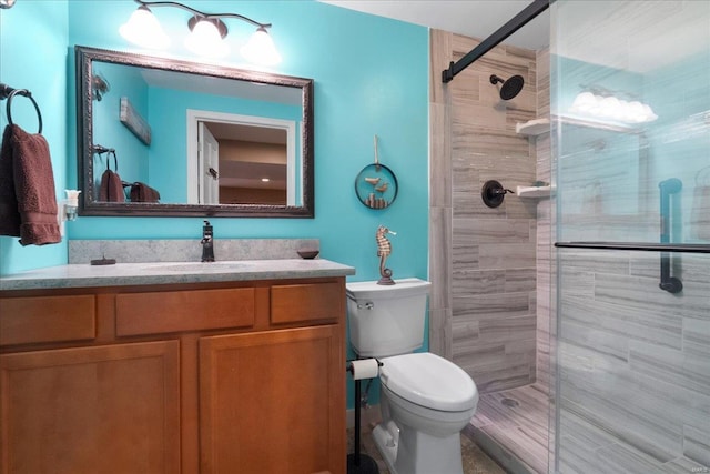 full bath with toilet, a stall shower, and vanity