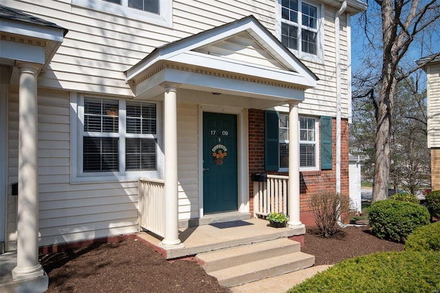 property entrance with brick siding