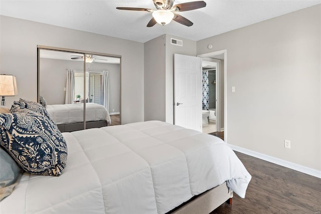 bedroom featuring baseboards, visible vents, ceiling fan, dark wood-style flooring, and a closet