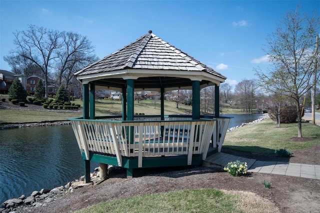 dock area with a water view, a yard, and a gazebo