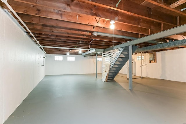 below grade area with electric panel and stairway