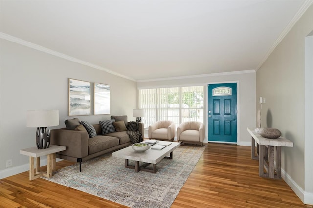 living area with crown molding, baseboards, and wood finished floors