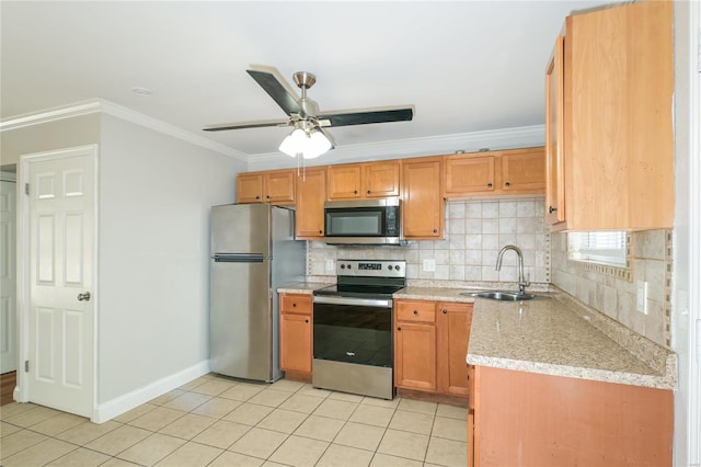 kitchen with appliances with stainless steel finishes, a sink, crown molding, backsplash, and light tile patterned flooring