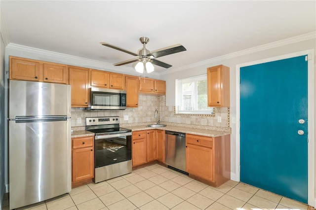 kitchen with light tile patterned floors, stainless steel appliances, a sink, and light countertops