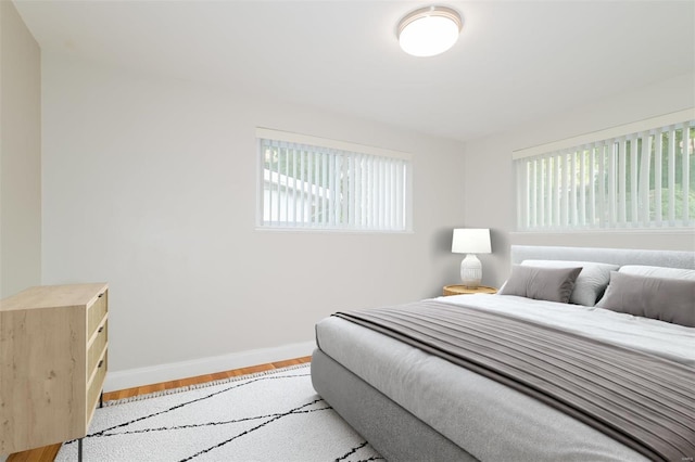 bedroom featuring baseboards and wood finished floors