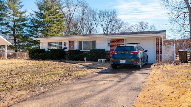 ranch-style house with a garage, driveway, and brick siding