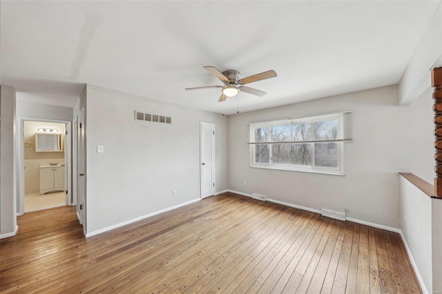 unfurnished bedroom with wood-type flooring, visible vents, and baseboards