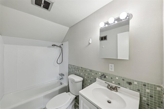 full bath featuring shower / bath combination, visible vents, toilet, vaulted ceiling, and vanity