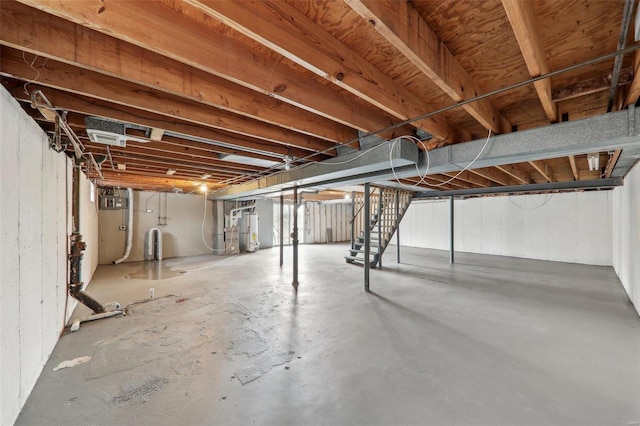 unfinished basement featuring water heater