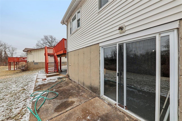 view of side of home featuring crawl space, stairs, and a wooden deck