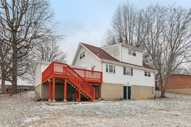 rear view of house featuring stairs and a wooden deck