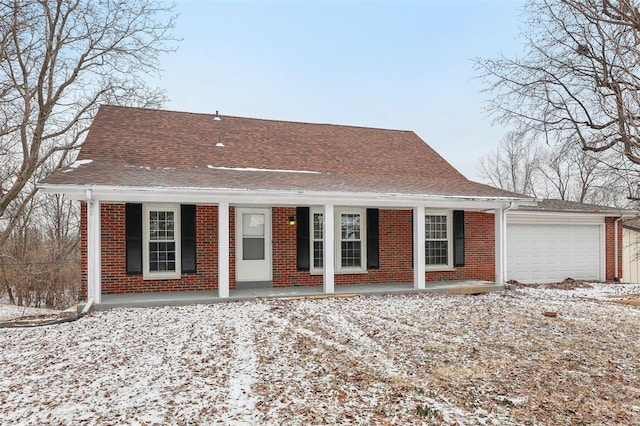 view of front of house featuring an attached garage, brick siding, a porch, and a shingled roof