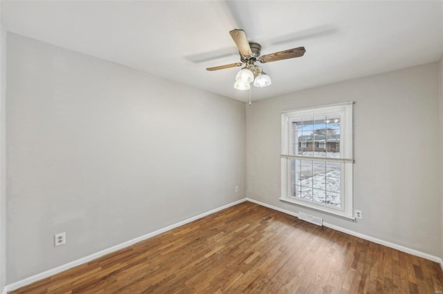 unfurnished room featuring a ceiling fan, wood-type flooring, visible vents, and baseboards