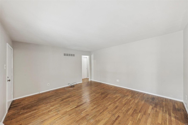 unfurnished room with light wood-style flooring, visible vents, and baseboards