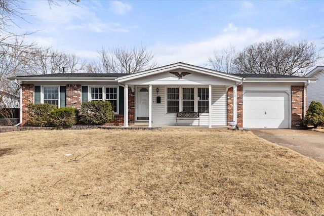 single story home with a garage, a front lawn, concrete driveway, and brick siding