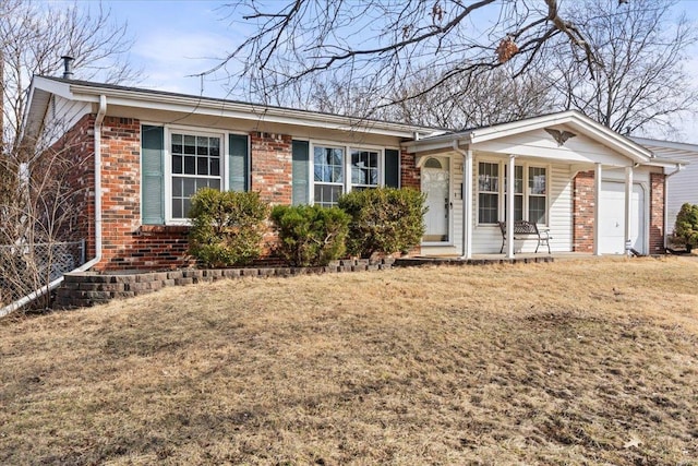 single story home with a garage, brick siding, a front lawn, and fence