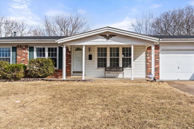 ranch-style house featuring brick siding, a front lawn, and an attached garage