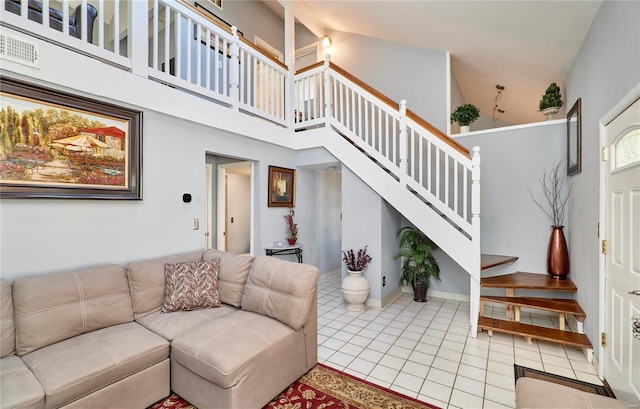 living room with visible vents, stairway, a high ceiling, and light tile patterned floors