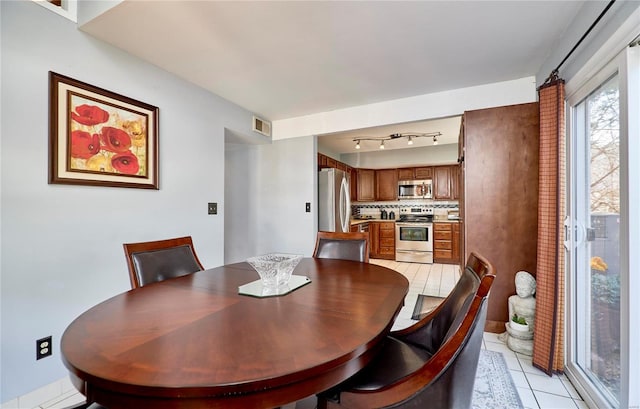 dining space with visible vents and light tile patterned flooring