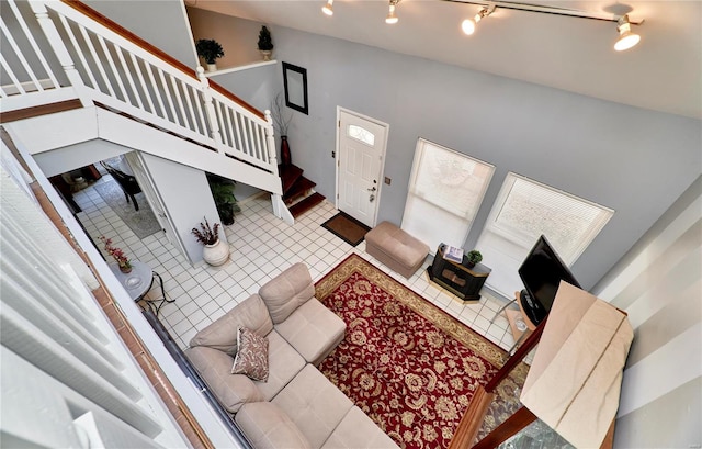 living room featuring stairway, track lighting, and tile patterned floors