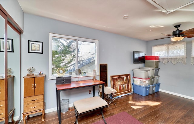 office area featuring dark wood-type flooring, baseboards, and a ceiling fan