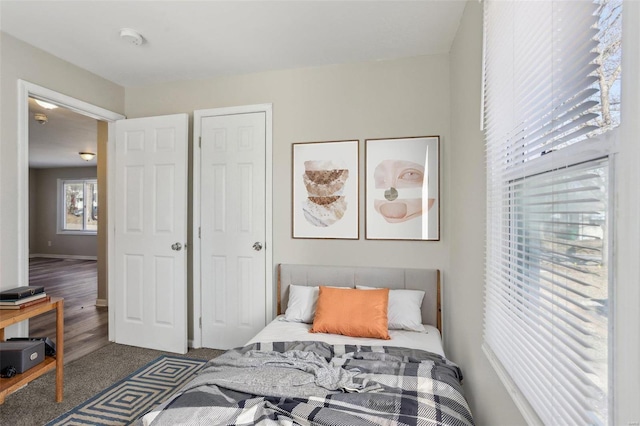 carpeted bedroom with baseboards