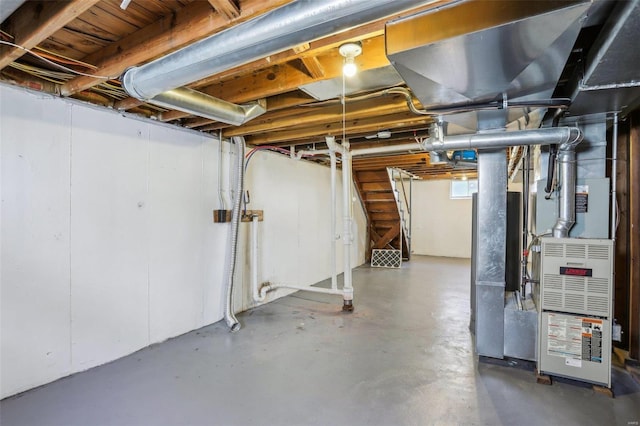 below grade area featuring heating unit and stairs