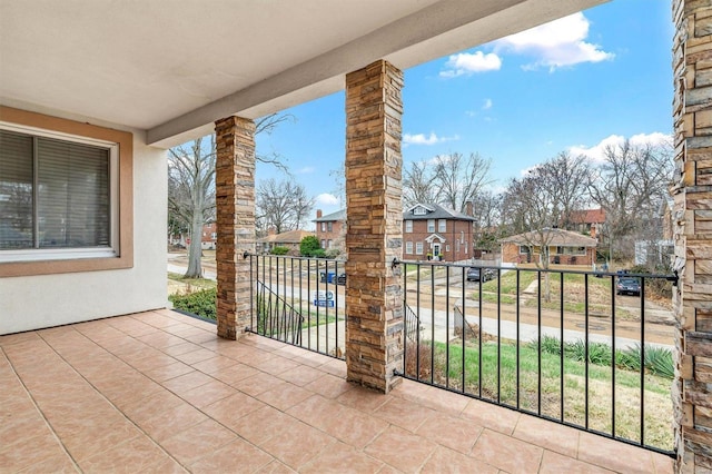 view of patio / terrace with a residential view and a balcony