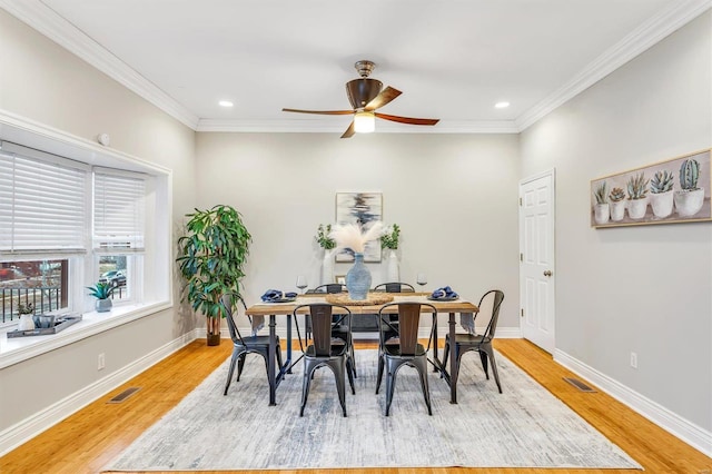 dining space featuring light wood-style floors, baseboards, and visible vents